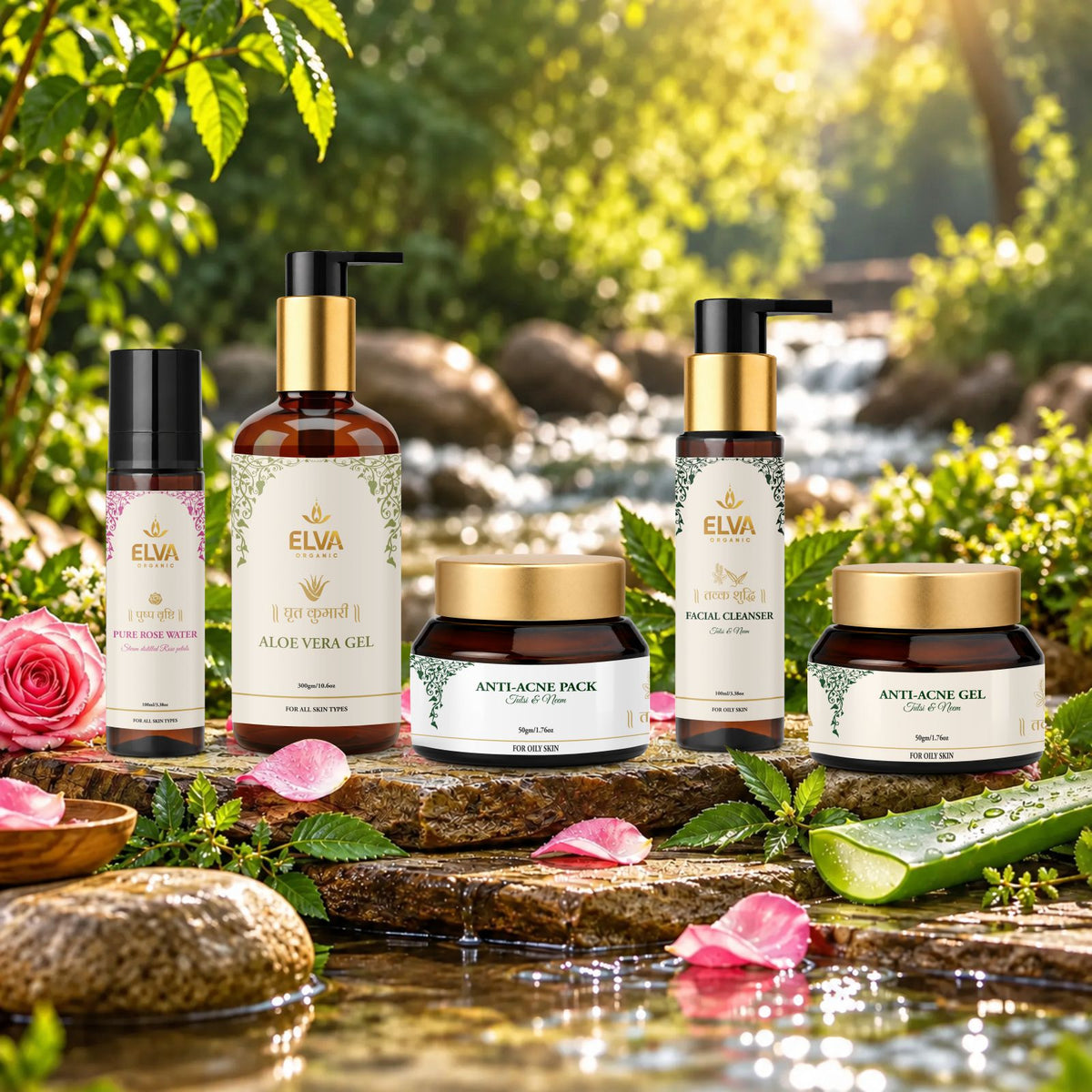 A set of five ELVA skincare products arranged on a rustic stone ledge outdoors near a flowing stream, with green foliage and pink flower petals in the background. The products include a rose water spray, aloe vera gel bottle, patch cleanser, anti-acne pack, and anti-acne gel.